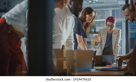 Diverse Team of Professional Businesspeople Meeting in the Office Conference Room. Creative Team Around Table, Specialist with Short Pink Hair Speak for Marketing Compain, Social Media Strategy
