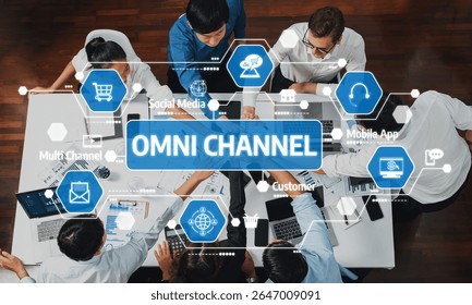 A diverse team of professionals collaborates on developing an omni channel strategy in a modern office space, leveraging digital tools and innovative ideas to enhance customer experience. Amity