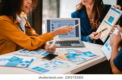 diverse team of professionals engaged in a website graphic design board meeting, sharing opinions on UX and UI design elements. Asian man, African American people, black, afro, caucasian female - Powered by Shutterstock