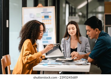 diverse team of professionals engaged in a website graphic design board meeting, sharing opinions on UX and UI design elements. Asian man, African American people, black, afro, caucasian female - Powered by Shutterstock - Get 15% off with code: PIKWIZARD15