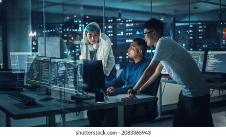 Diverse Team of Professionals Meeting in Office at Night: Brainstorming IT Programmers Use Computer Together, Talk Strategy, Discuss Planning. Software Engineers Develop Inspirational App Program