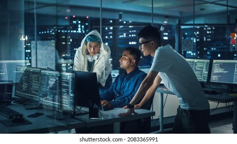 Diverse Team Of Professionals Meeting In Office At Night: Brainstorming IT Programmers Use Computer Together, Talk Strategy, Discuss Planning. Software Engineers Develop Inspirational App Program