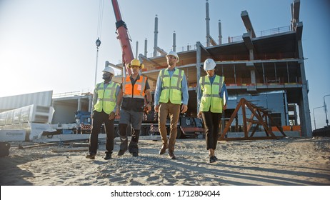 Diverse Team of Specialists Inspect Commercial, Industrial Building Construction Site. Real Estate Project with Civil Engineer, Investor and Worker. In the Background Crane, Skyscraper Formwork Frames