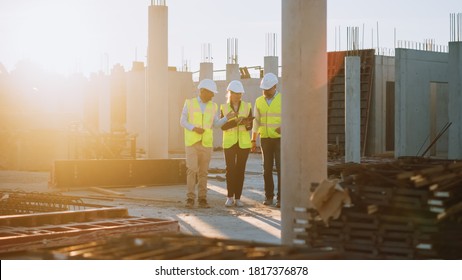 Diverse Team of Specialists Taking a Walk Through Construction Site. Real Estate Building Project with Senior Civil Engineer, Architect, General Worker Discussing Planning and Development Details. - Powered by Shutterstock