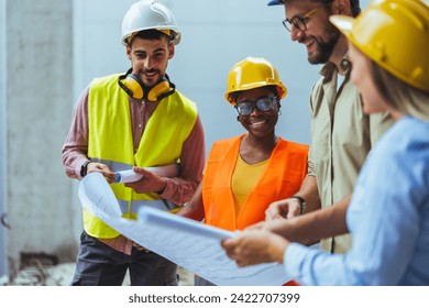 Diverse Team of Specialists Taking a Walk Through Construction Site. Real Estate Building Project with Senior Civil Engineer, Architect, General Worker Discussing Planning and Development Details. - Powered by Shutterstock