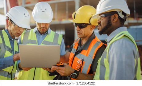 Diverse Team of Specialists Use Laptop Computer on Construction Site. Real Estate Building Project with Civil Engineer, Architectural Investor, Businesswoman and Worker Discussing Blueprint Plan