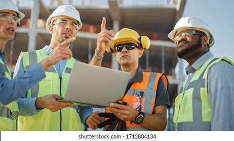 Diverse Team Of Specialists Use Laptop Computer On Construction Site. Real Estate Building Project With Civil Engineer, Architectural Investor, Businesswoman And Worker Discussing Blueprint Plan