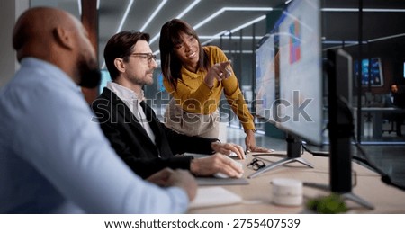 Diverse Team Using Computers To Analyze Data And Manage Business Performance, Possibly As Analysts, Managers