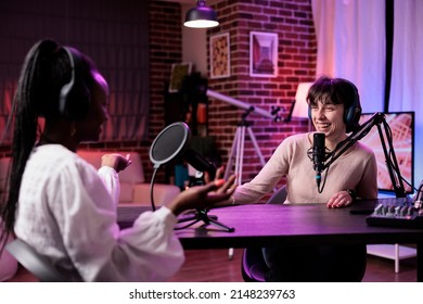 Diverse Team Of Women Meeting In Studio To Livestream Podcast Chat Together, Creating Content For Social Media Channel. Female Influencers Using Professional Recording Equipment At Station.