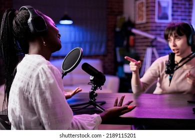 Diverse Team Of Women Meeting In Studio To Talk On Podcast, Recording Episode Show With Equipment. People Having Conversation For Audience On Social Media Channel, Livestream.