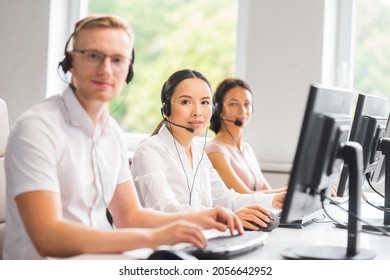 Diverse Team Of Young Professionals Is Working In The Phone Support Office. Working Day Of Sales Managers In The Call Center. Business, Telephone Consulting And Problem Solving.