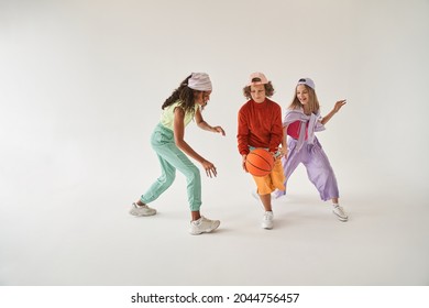 Diverse Teenagers Playing At The Basketball While Running Isolated Over White Background