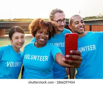 Diverse volunteers taking a selfie together - Shutterstock ID 1866297454