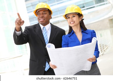 A diverse  woman and man working as architects on a construction site (Focus on Woman)