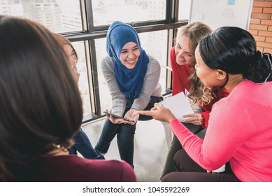 Diverse Women Sitting In Circle Enjoying Sharing Stories In Group Meeting