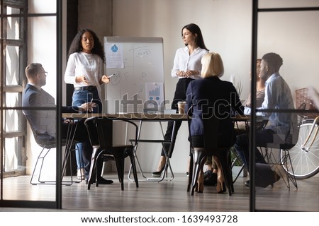 Diverse women startupper multiracial and european ethnicity make perform presentation for investors during meeting at office boardroom staff listening coaches attending at educational training concept