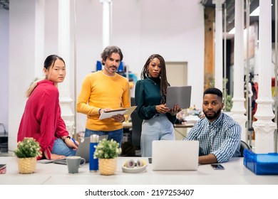 Diverse Work Team Looking At Camera And Holding Office Equipment. Co-working Concept