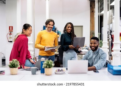 Diverse Work Team Smiling And Looking At Camera And Holding Office Equipment. Co-working Concept