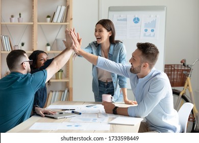 Diverse Workers With Female Mentor, Coach Giving High Five At Company Meeting. Happy Female Teacher With Colleagues Celebrating Achievement, Corporate Success Of Teamwork, Team Building Activity.