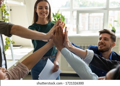 Diverse workers with happy female leader, coach giving high five at company meeting, woman teacher with students celebrating achievement, corporate success of teamwork, team building activity. - Shutterstock ID 1721326300