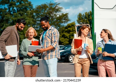 Diverse young Business people outdoor in the street. Multiethnic employees with laptop and files in  corporate district. Copy space - Powered by Shutterstock