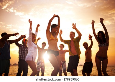 Diverse Young Happy People Dancing at Sunset