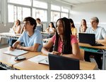 Diverse young high school students listening to teacher in classroom. Education lifestyle and lecture concept