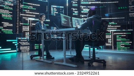 Diverse Young Man and Woman Working on Desktop Computers, Surrounded by Big Screens Displaying Code Lines. Professional Computer Engineers Developing Autonomous Algorithm for Generative AI