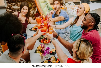 Diverse Young People Having Fun Celebrating Cocktails - Happy Friends Enjoying Time At Home Party Sitting In Villa Backyard - Summer Lifestyle And Food And Drink Concept.