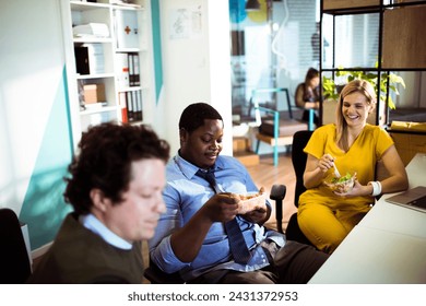 Diverse young people sharing corporate lunch at the office - Powered by Shutterstock