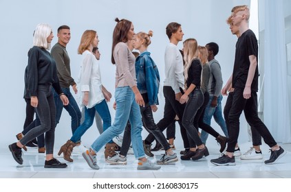 Diverse Young People Walking In Different Directions.