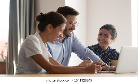 Diverse young positive business people laughing during workshop meeting, watching funny video, joking via video call, resting during break time. Successful multiracial employee team having fun. - Shutterstock ID 1541328245