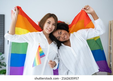 Diversity African American and Asian Married couples Lesbian LGBTQ. Married homosexual show Diamond ring.Sexual equality,LGBT Pride month,Parade celebrations concept.Family of happiness smiling.