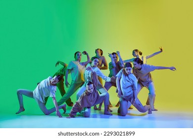 Diversity, chaos and freedom. Group of young people dancing contemp against gradient background in neon light. Concept of modern freestyle dance, contemporary art, movements, hobby, creative lifestyle - Powered by Shutterstock