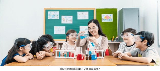 Diversity children student doing a chemical experiment in laboratory at school. Portrait of happy kids at elementary school learn science chemistry with asian teacher. Fun study back to school banner - Powered by Shutterstock