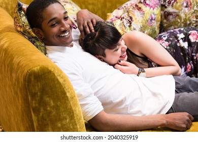 Diversity Couple Relaxing On Sofa