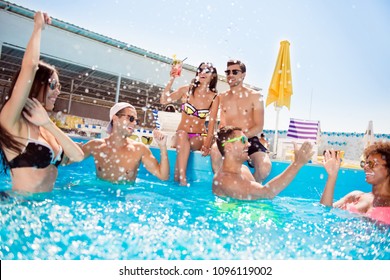 Diversity couples students recreation entertainment careless glasses eyewear delightful people concept.  Excited cheerful joyful relaxed teen youth celebrating summer season moving in blue clear pool - Powered by Shutterstock