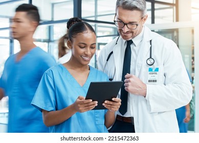 Diversity, Doctor And Nurse On A Tablet Planning A Surgery Strategy Or Talking About Medical Results In A Hospital. Teamwork, Collaboration And Happy Healthcare Workers Speaking And Reading A Report