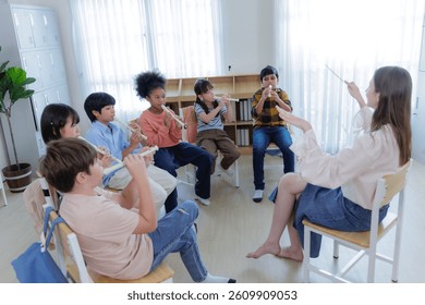 Diversity of elementary students learning in classroom music lesson with recorders