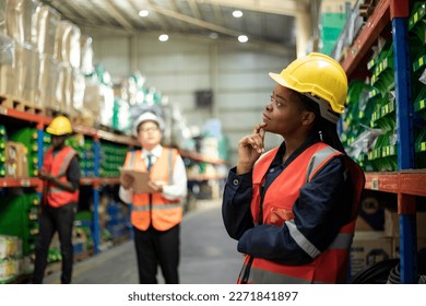 Diversity of employee warehouse worker in safety vest and helmet working with tablet for checking products or parcel goods on shelf - Powered by Shutterstock