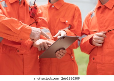 Diversity engineer worker working with digital tablet. Hand of factory workers working, training and planing togeter at workplace. Cooperation of workers. Unity and teamwork concept