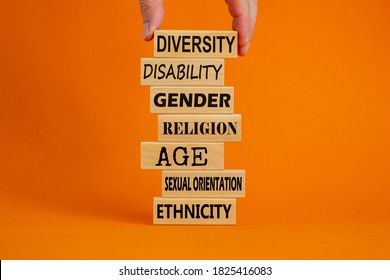 Diversity ethnicity gender age sexual orientation religion disability words written on wooden block. Male hand. Beautiful orange background. Equality and diversity concept.