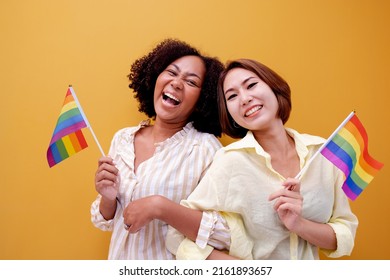 Diversity Female Group Cheerful Young Group Of Women With Rainbow Flag Gay Pride While Leisure In The Park. Concept Of Homophobia And Diversity Lesbians.Supporters Of The LGBT Community.African Asian