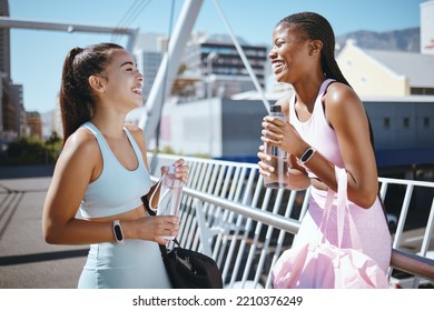 Diversity, Fitness And Friends Laughing While Drinking Water To Hydrate After Training, Exercise And Running Outdoors In USA. Smile, Healthy And Happy Black Woman Enjoys A Funny Joke With Latino Girl