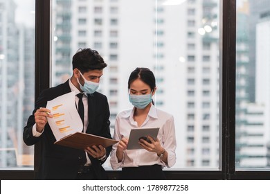 Diversity Group Of Businessperson Wear Face Mask, Face Shield, Keep Social Distancing As New Normal Working Lifestyle In Office Business After Covid 19 Pandemic