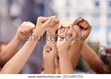 Diversity, hands and fist in community protest for human rights, racism and equality in fight for justice in the city. Group hand of people in strike for economic or government change in a urban town