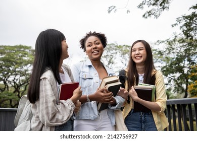 Diversity Of Happy Woman Student Holding Books And Looking At Natural Outdoors At Park. Prepare For College And University Concept. Informal Education And Natural Research