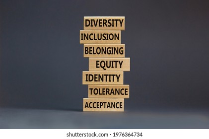 Diversity, inclusion symbol. Diversity belonging inclusion equity identity tolerance acceptance words written on wooden block. Beautiful grey background. Diversity, inclusion and belonging concept.