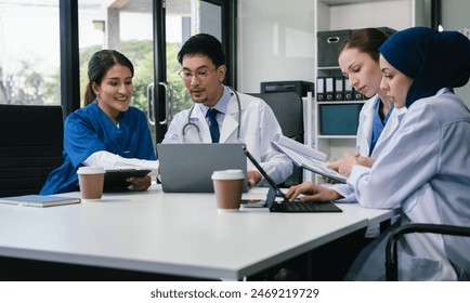 Diversity, Medical team working on digital tablet healthcare doctor technology tablet using computer analyzed the results of medical reports, an online conference at the hospital. - Powered by Shutterstock