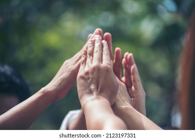 Diversity multiethnic high five group of business people success team hands together. Collaborate Volunteer friendship hands raise up mission Business partner. Group of teamwork high five together - Shutterstock ID 2123197331